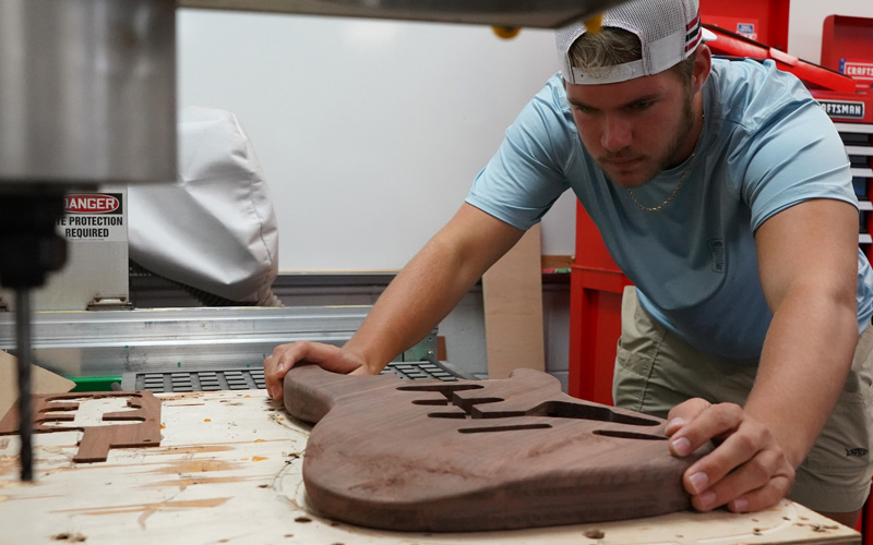 Engineering Design Student working on electric guitar